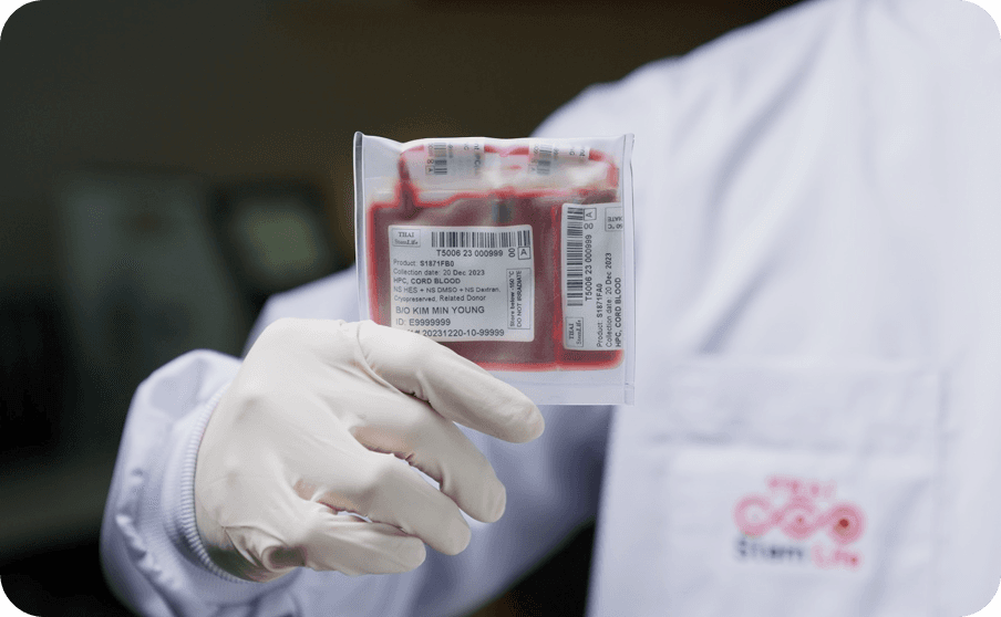 Gloved hand holding blood bag